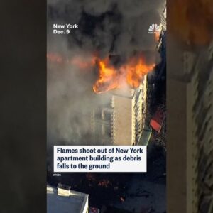 Flames shoot out of NYC apartment building as debris falls to the ground