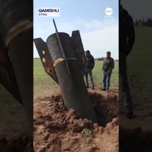 People gather around unexploded missile intercepted by NATO over Syria