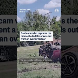 Dashcam video captures the moment a toddler crawls out from an overturned car