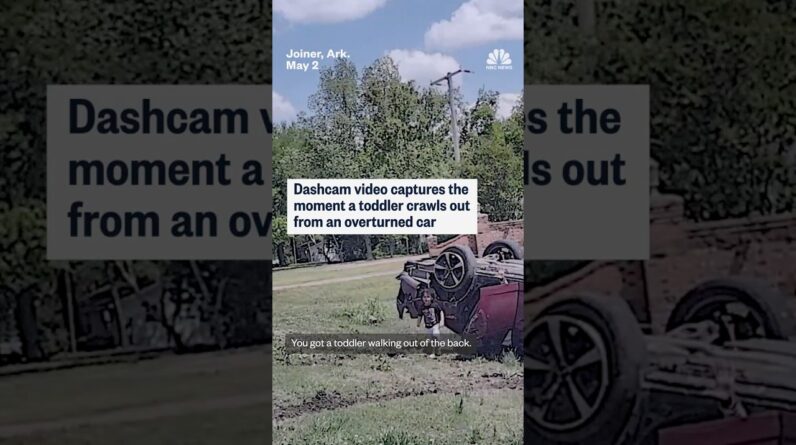 Dashcam video captures the moment a toddler crawls out from an overturned car