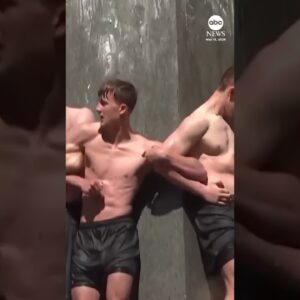 Naval Academy plebes scale the greased Herndon Monument